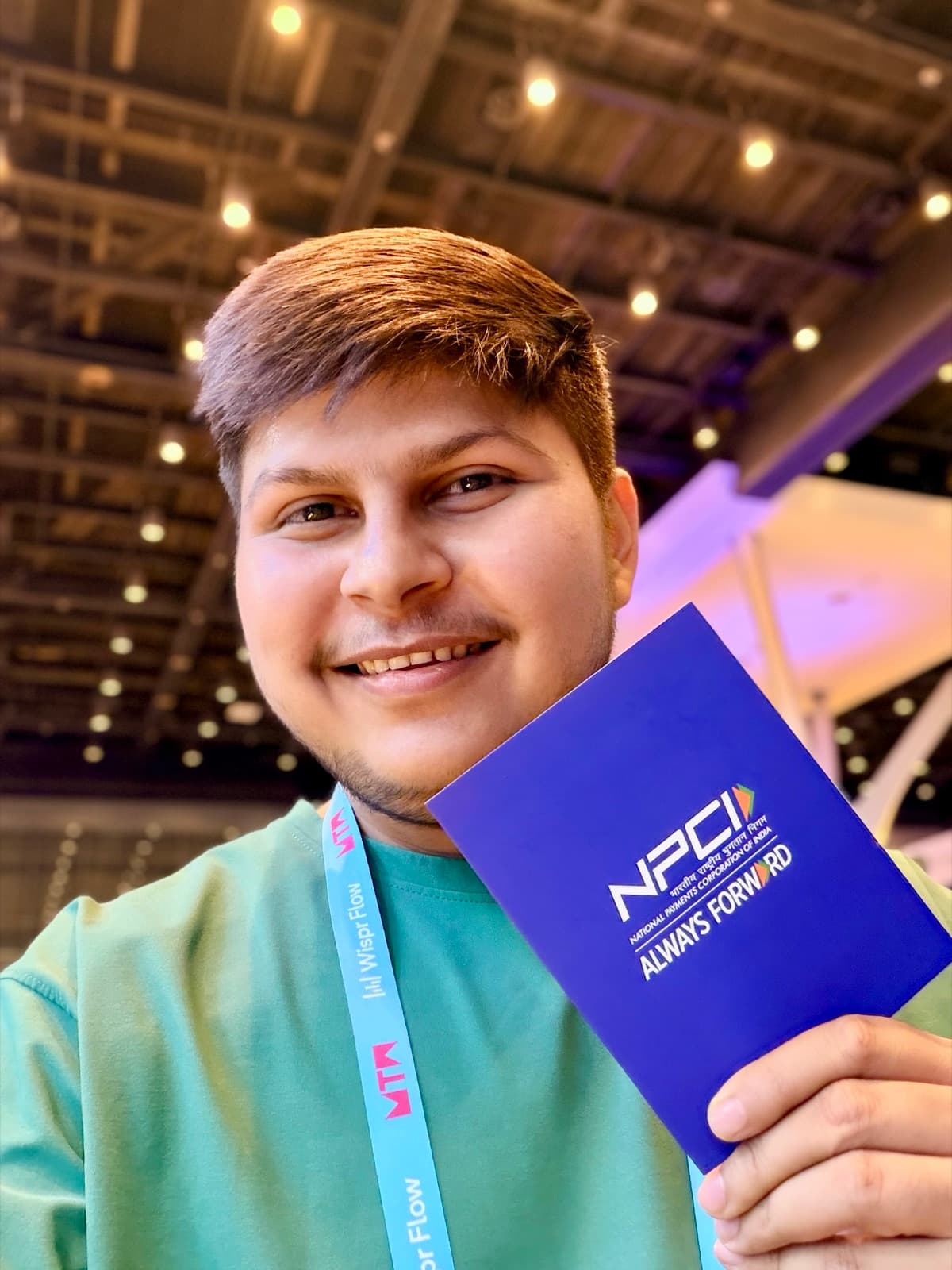 Meet Jariwala holding an NPCI booklet at a conference