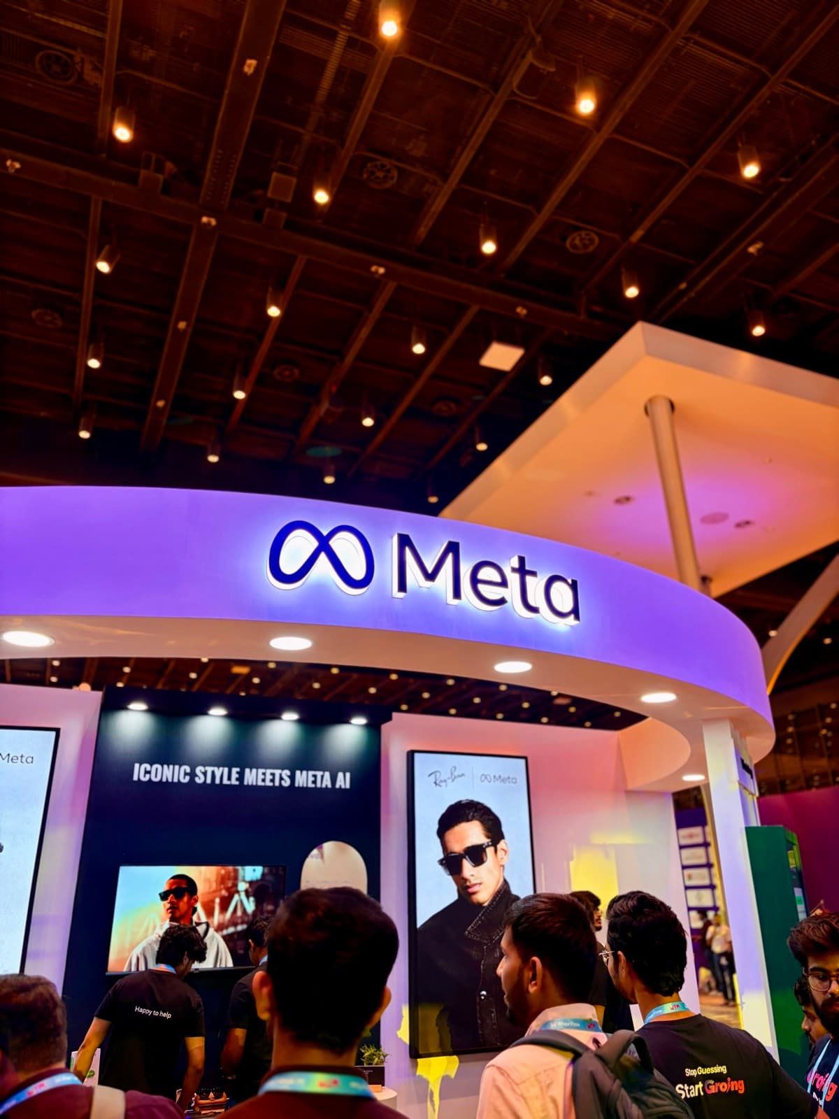 The Meta stand lit up above the crowd at a technology conference